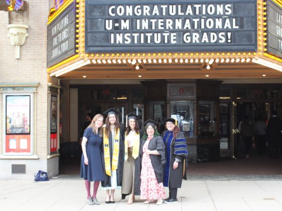 Graduates under Michigan Theater marquis