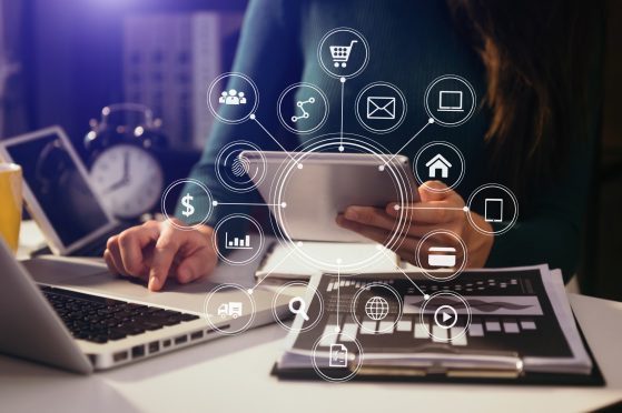 Businesswoman working with smart phone and laptop and digital tablet computer in office with digital marketing media in virtual icon