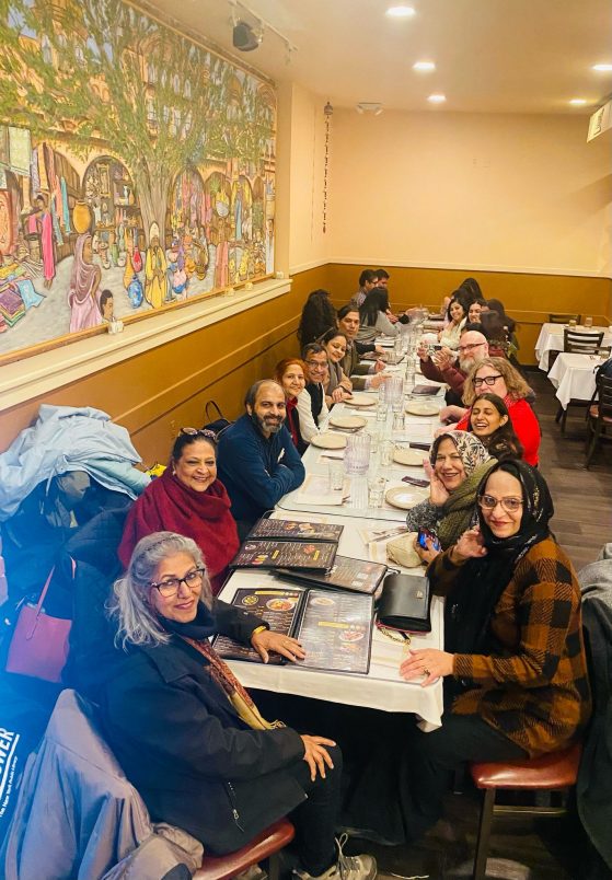 Group of people sitting at a long dinner table