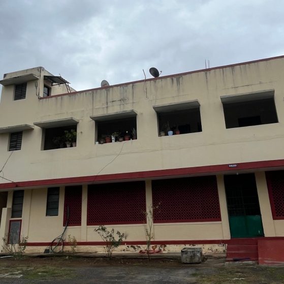 A large empty building under a cloudy grey sky