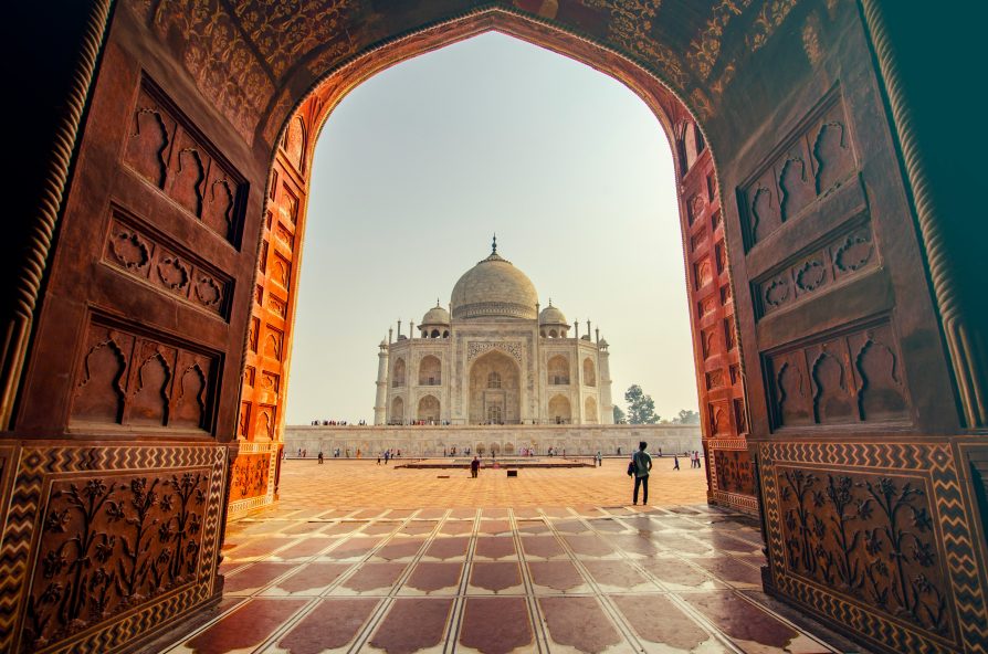 Photo of the Taj Mahal with a small crowd of people standing outside