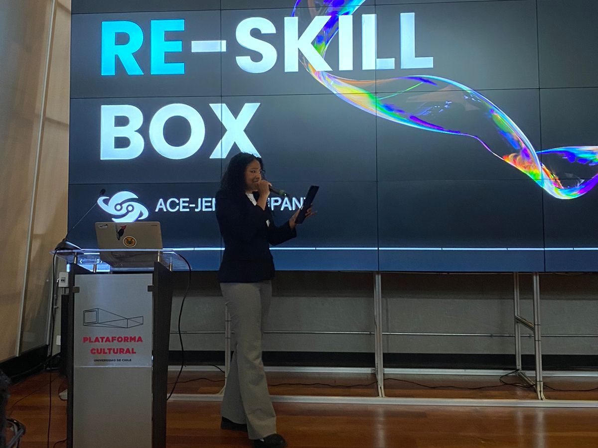 Ashley Smith speaks on the stage of the Association of Pacific Rim Universities conference in Santiago, Chile