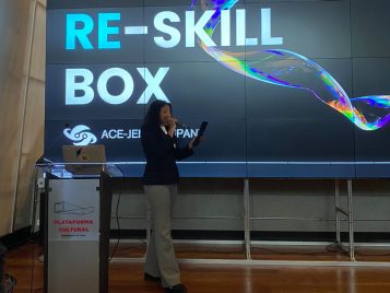 Ashley Smith speaks on the stage of the Association of Pacific Rim Universities conference in Santiago, Chile