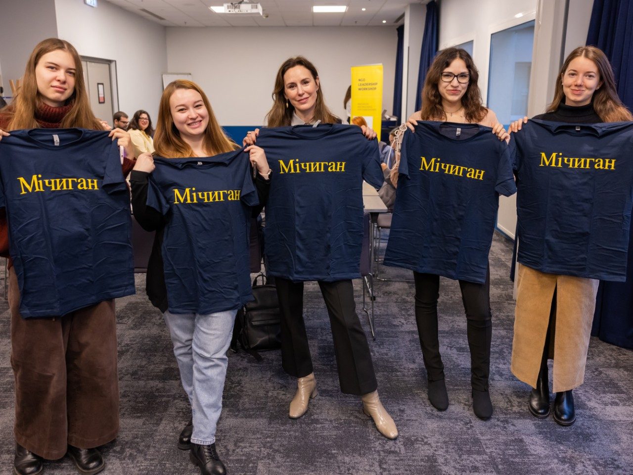 WCEE Director Geneviève Zubrzycki (center) and Ukrainian NGO leaders holding up “Мічиган” [Michigan in Ukrainian] t-shirts