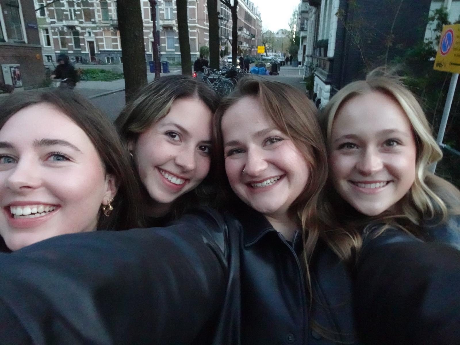 Emma posing with friends in Amsterdam