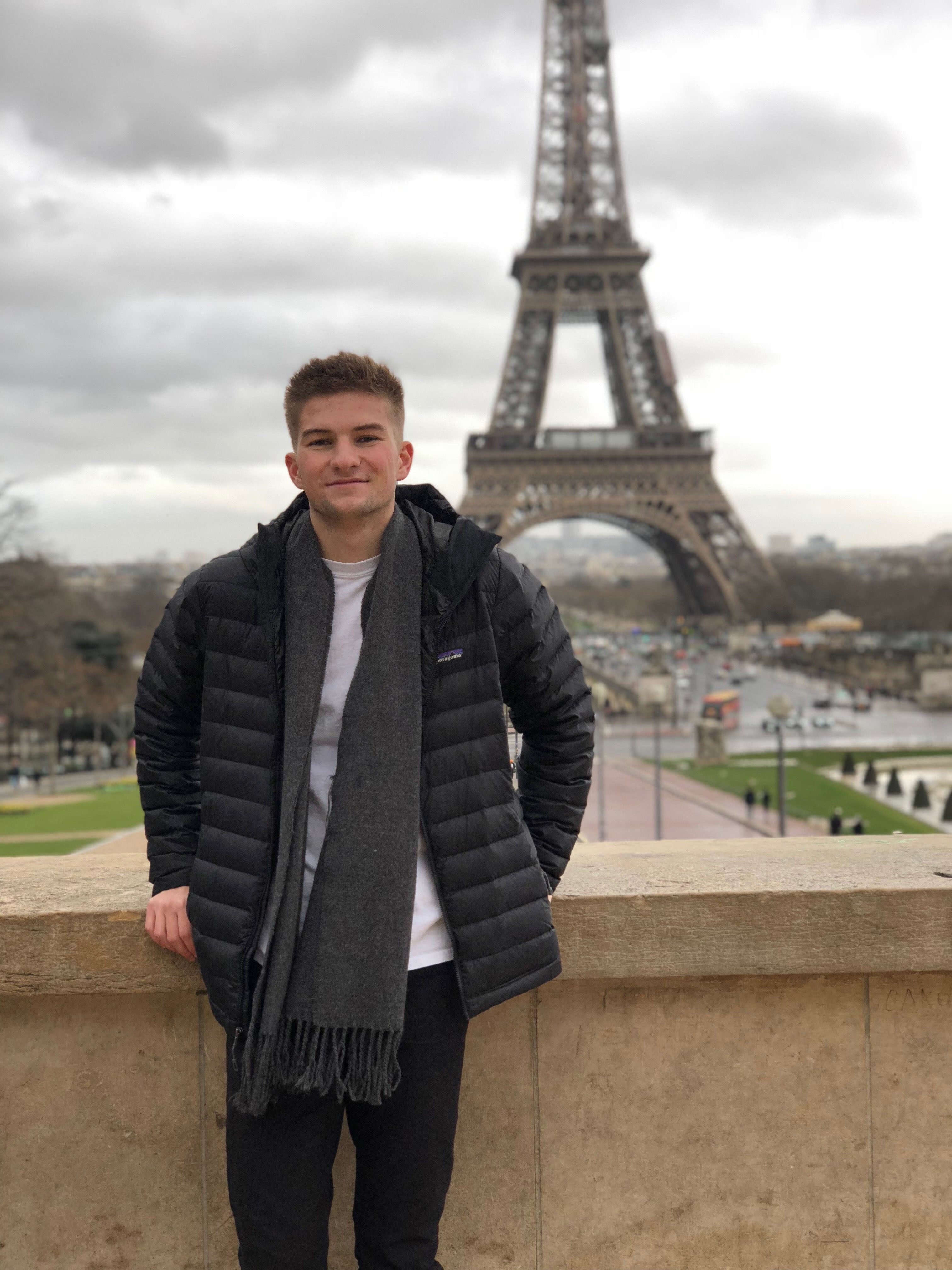 Ryan poses in front of the Eiffel Tower.