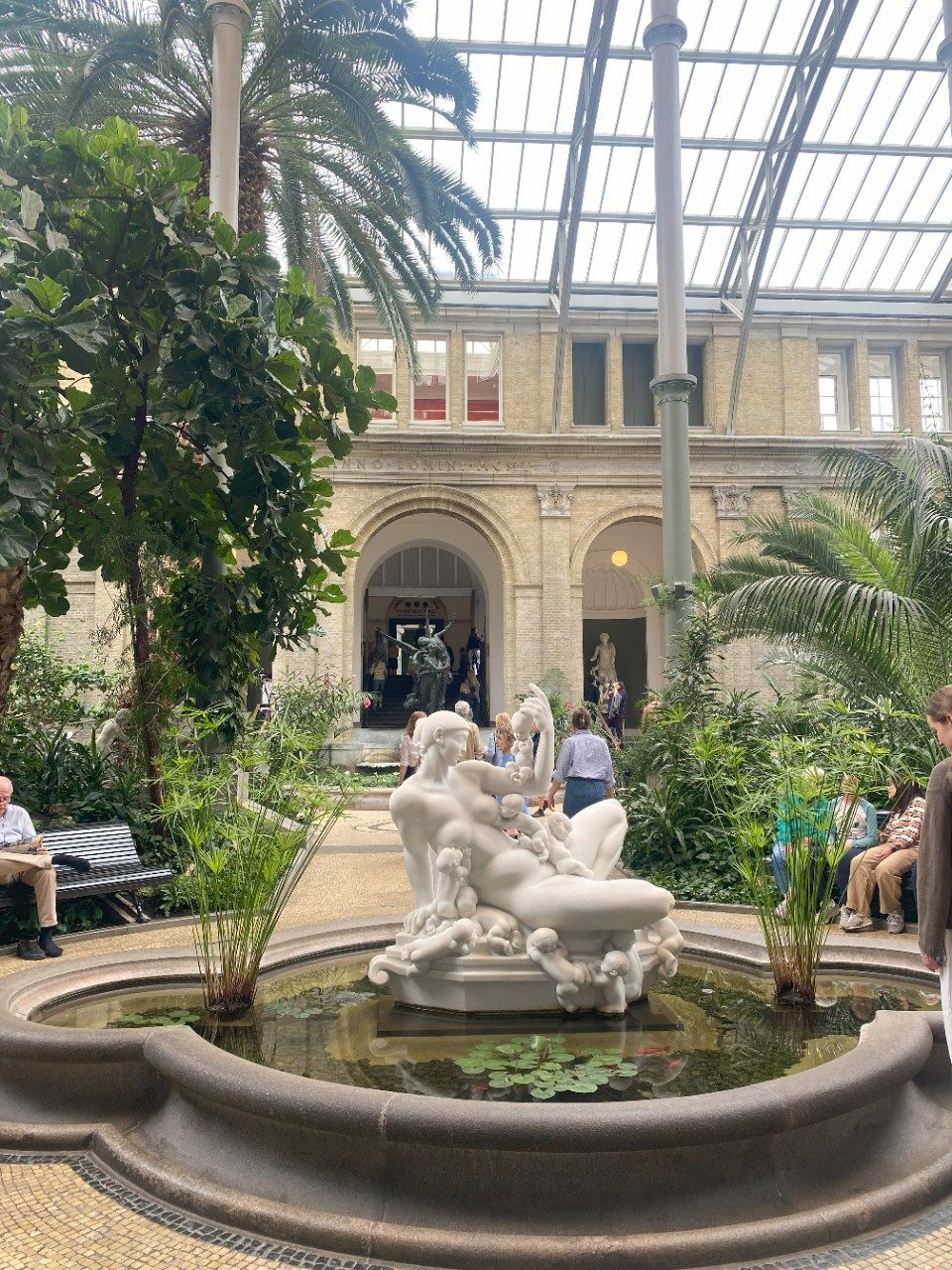 Beautiful water pond and carved sculpture at the Glyptoteket art museum.