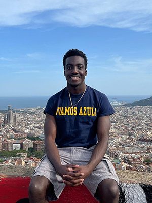 Peter posing outside on a wall overlooking Barcelona