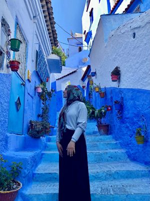 Razaan posing infront of a colorful staircase