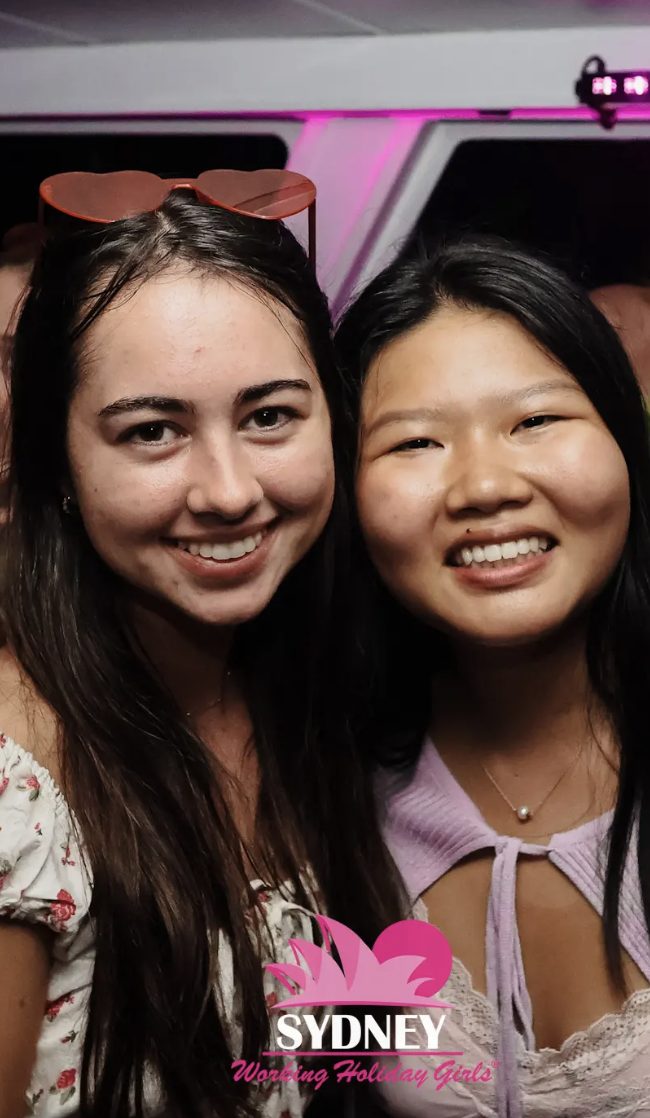Mandy and her friend smile during a boat party.