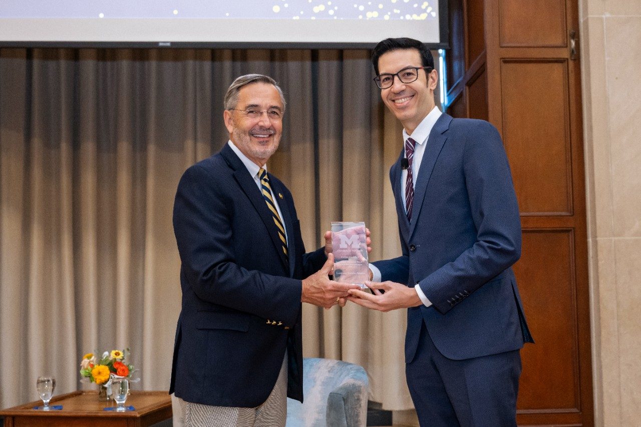 President Domenico Grasso and Lorenzo García-Amaya pose for a photo with the President's Award for Leadership in International Education in hand.