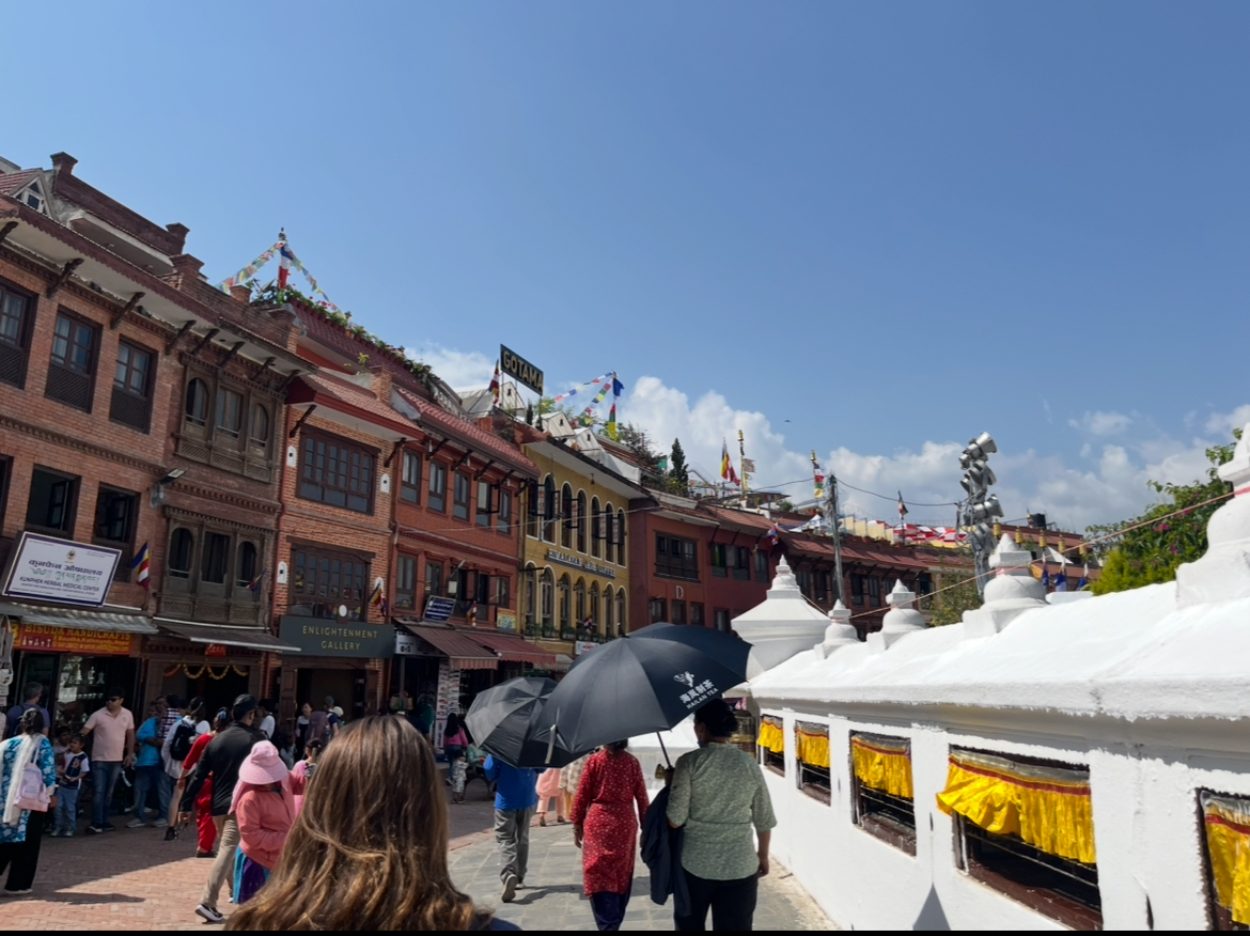 The bustling streets surrounding the Stupa (Right), shops, restaurants, and guest houses (Left) line the perimeter.