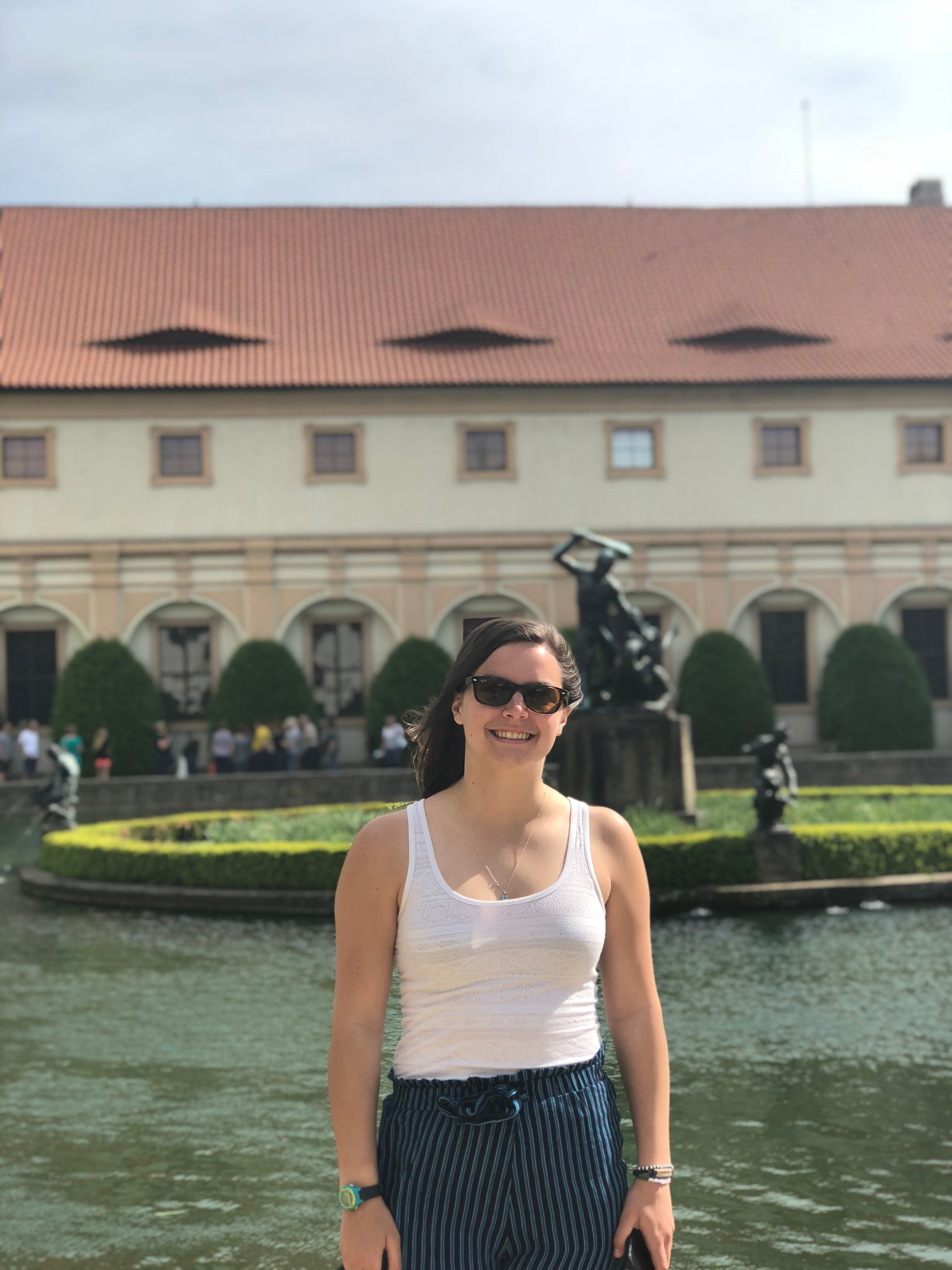 Margot poses for a photo in front of a fountain. 