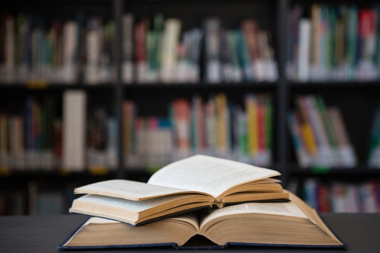 An open book lays on a table in a library, symbolizing how you can get out of the classroom and learn abroad.