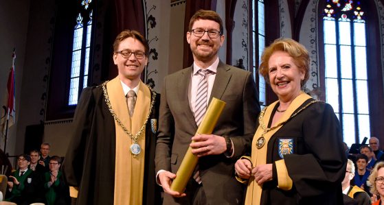 Prof. Andrei Levchenko presented with an honorary doctorate by the Dean Prof. Alois Stutzer.