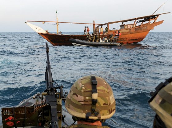 A photograph of international naval forces monitoring suspected pirate crafts