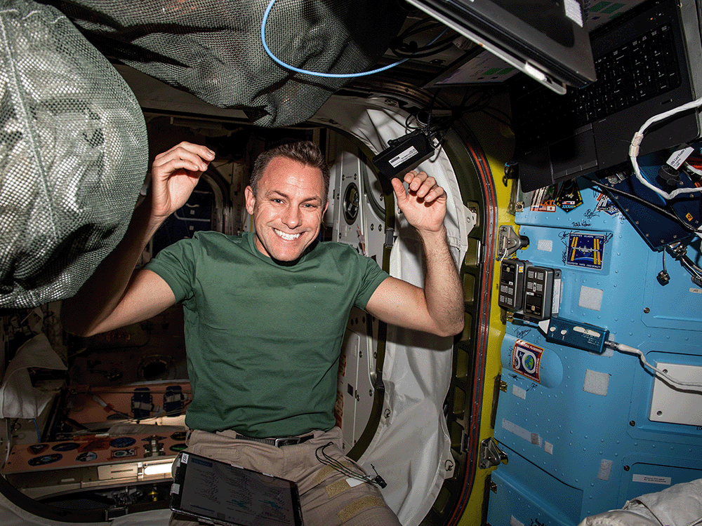 Astronaut Josh Cassada works inside the Quest airlock at the International Space Station