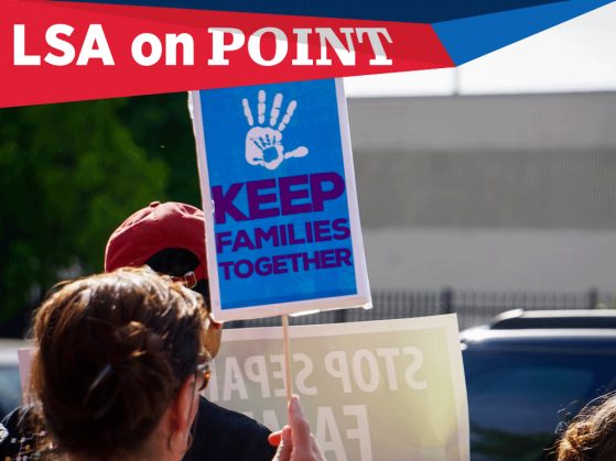 A photograph of a a sign that says Keep families together beneath a child's hand print. The photograph also has a text flag that says LSA on Point.