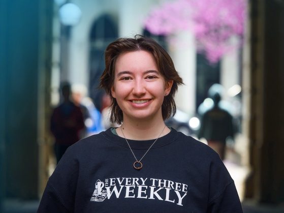 A person wearing a shirt that says "Every Three Weekly" smiles directly at the camera.