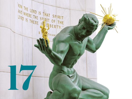 The “Spirit of Detroit” bronze sculpture holds a sphere in one hand and a family in the other. A stylized numeral 17 is also pictured.