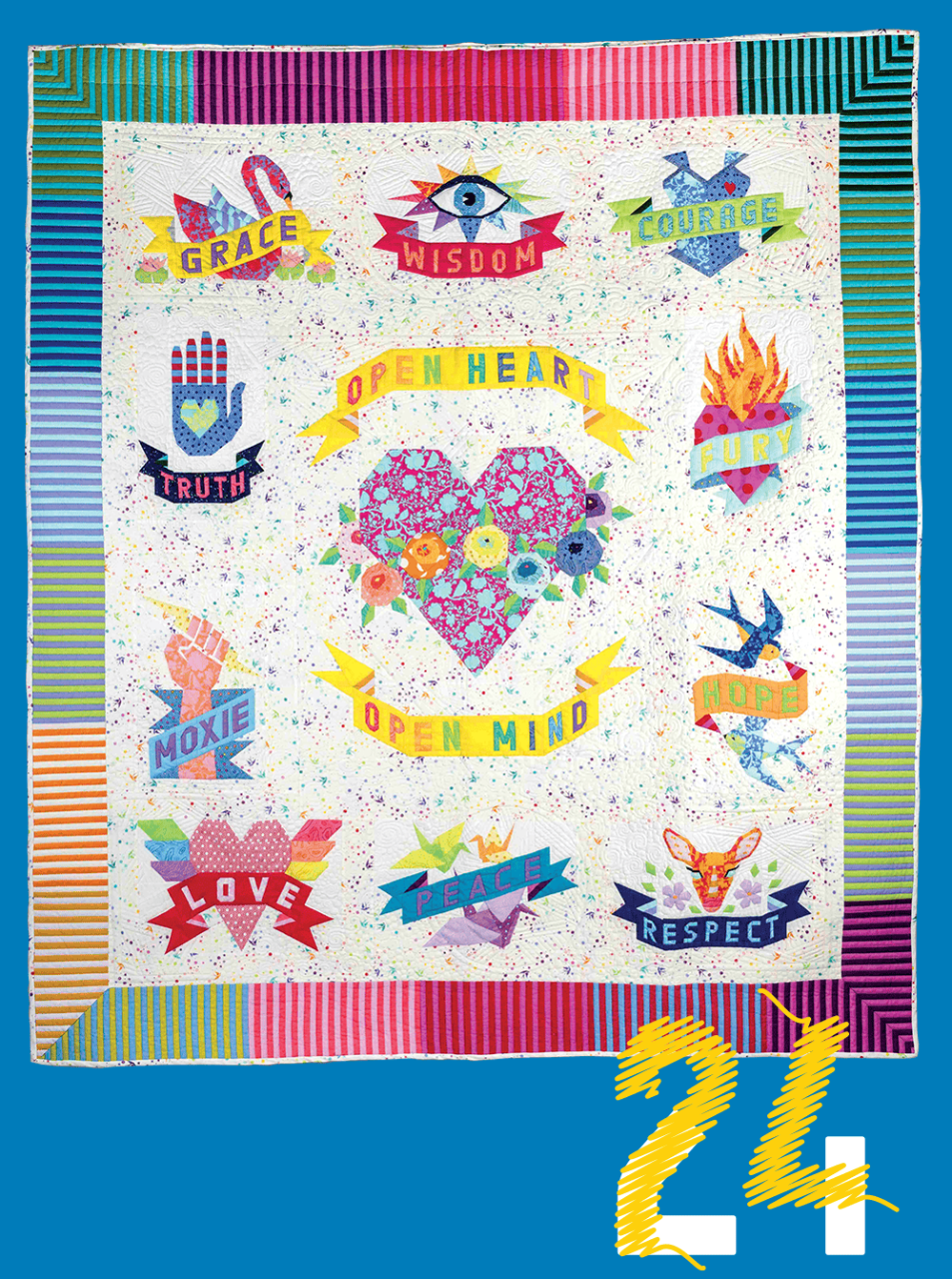 A quilt with a heart at the center and the words “open heart, open mind,” as well as grace, wisdom, courage, truth, fury, moxie, truth, love, peace, and respect, and a variety of related symbols. The numeral 24 appears to be sewn with yellow stitching.
