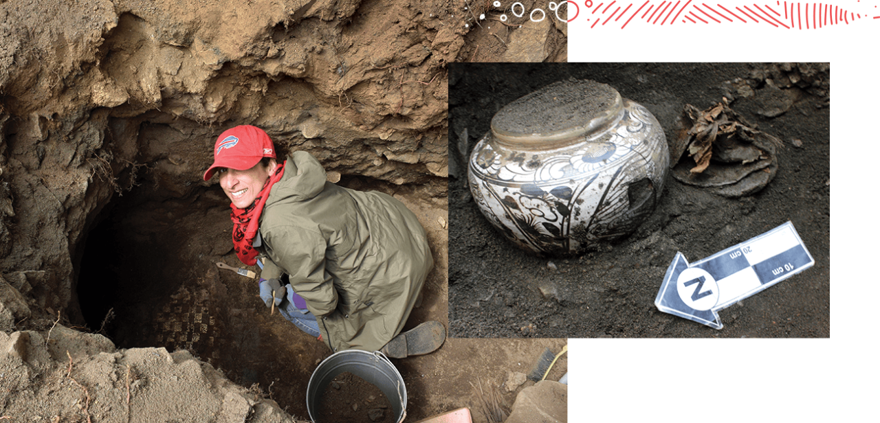 A person looks up from a hole in the ground where she is surrounded by archaeological tools. A stoneware pot sits on black dirt.