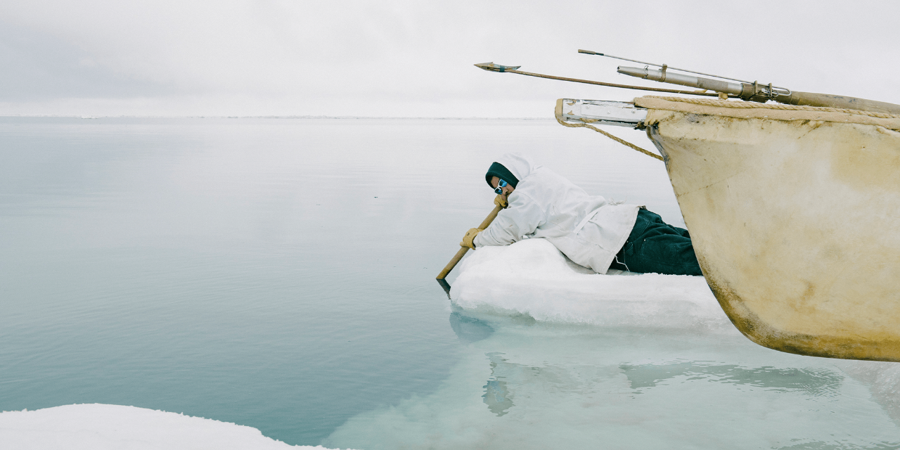 A man listens for whales through an oar