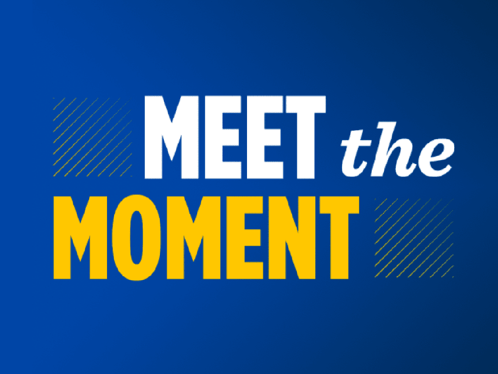 A blue banner that reads “Meet the Moment.”