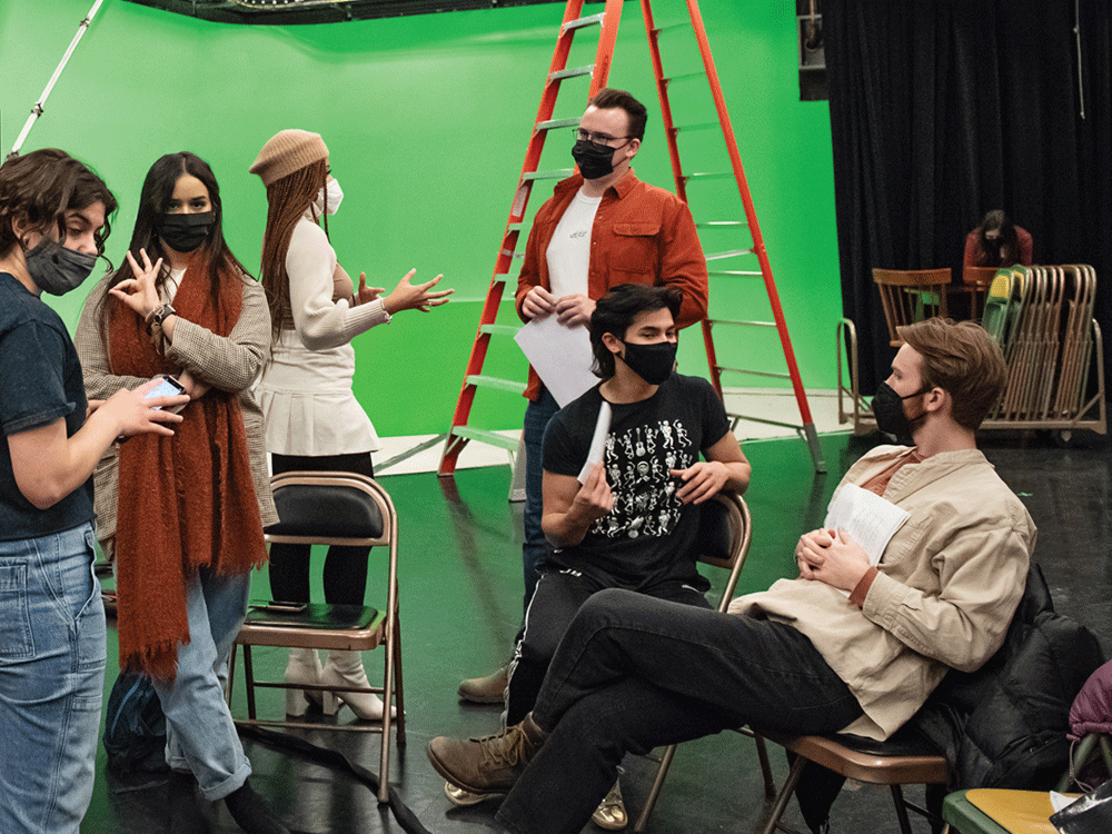  FTVM students gather around a green wall during production of Ashley Morrow’s screenplay.