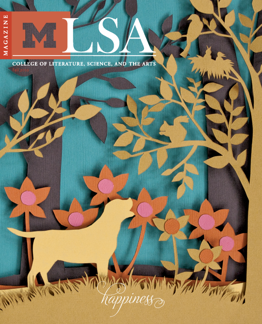 Magazine cover for the University of Michigan LSA (College of Literature, Science, and the Arts) Fall 2010 issue. The design features a colorful paper-cut illustration with a yellow dog standing in a vibrant forest scene. Surrounding the dog are orange and pink flowers, leafy trees, a squirrel on a branch, and a bird sitting in a nest, all set against a teal blue background. At the bottom, the word "happiness" is written in elegant script. LSA Magazine title and the block “M” logo appear at the top of the cover.