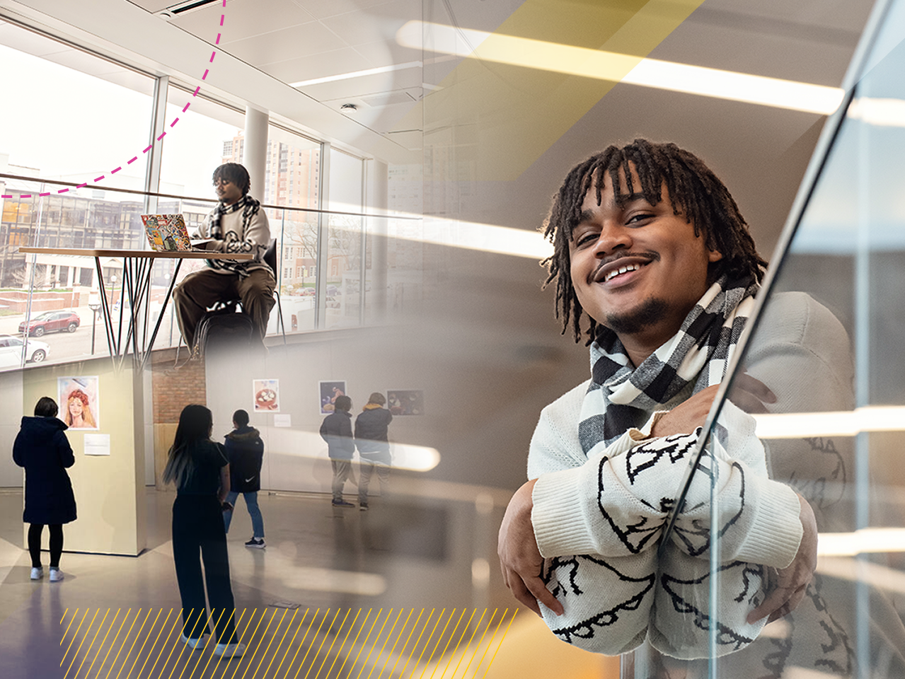 Jaylen leans over a railing and is smiling at the camera. The image behind him is of an art gallery, with patrons browsing the art.