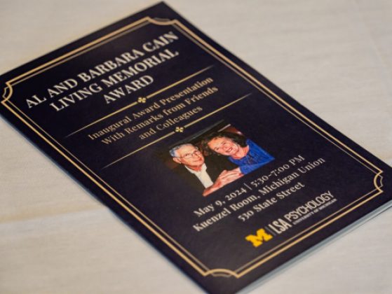 The cover of the program for the Al and Barbara Cain Memorial Award Inaugural Award Presentation. The program is navy blue with gold lettering and border and features a photo of Al and Barbara Cain together. The program also states, With Remarks from Friends and Colleagues, as well as the date, time, and location of the event, May 19, 2024, 5:30-7:00 PM, in the Kuenzel Room at the Michigan Union., 530 S. State St.