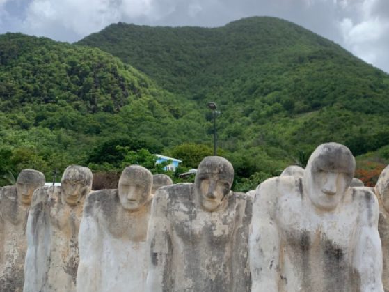 Solemn concrete figures on a hillside