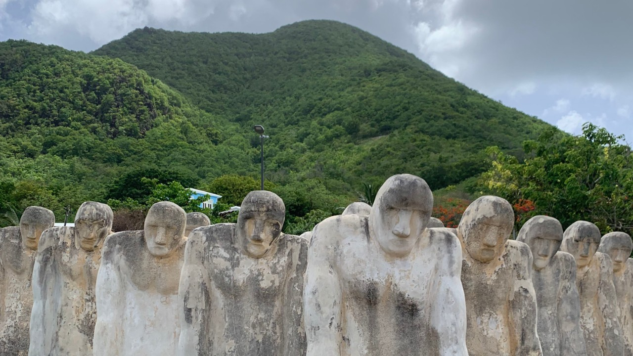 Solemn concrete figures on a hillside