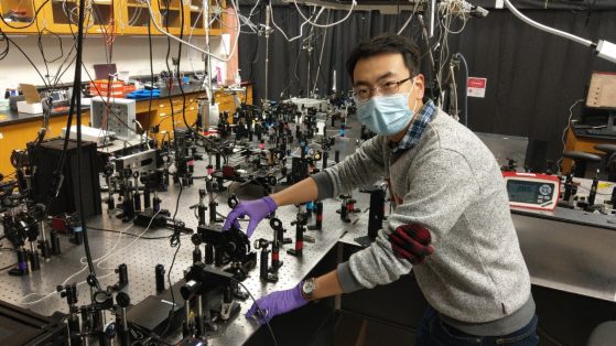 Xiaoyu Guo is pictured in his lab wearing a protective face mask.