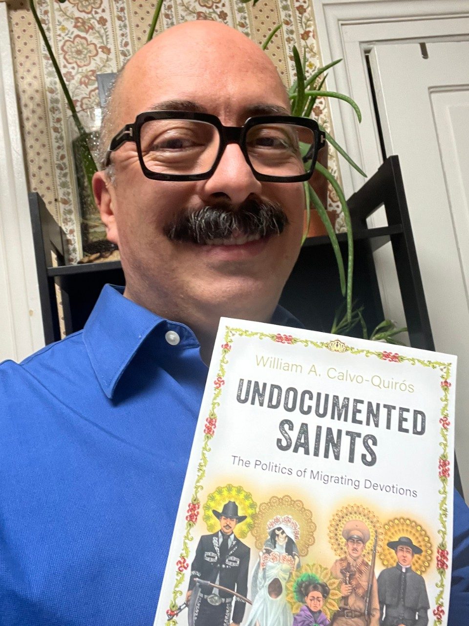 Dr. Calvo-Quiros holding his book 