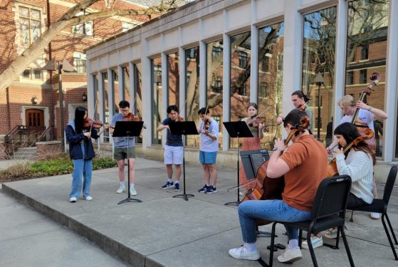chamber music students play an outdoor concert in the east quad courtyard