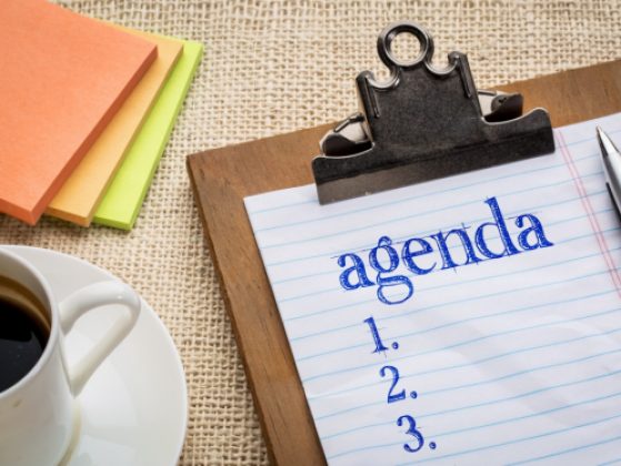 agenda list on clipboard and coffee