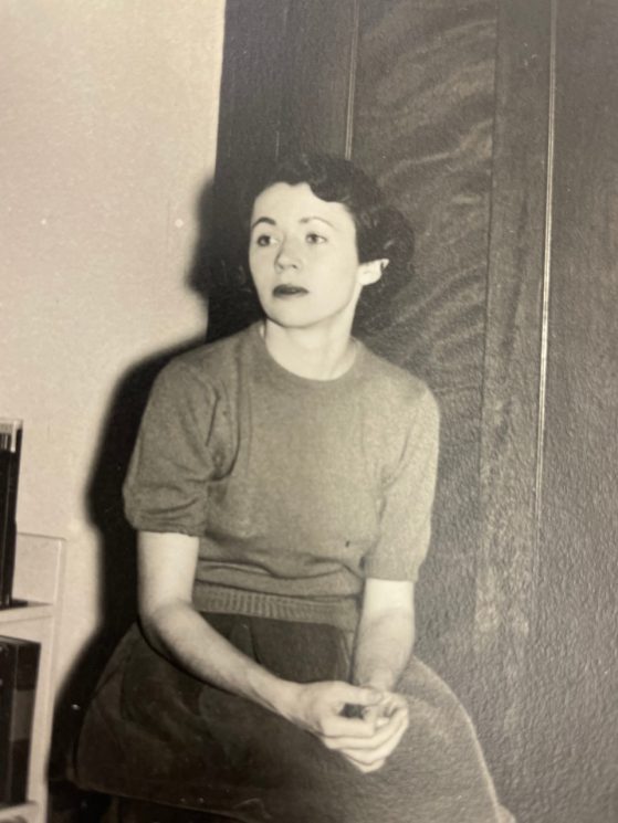 Black and white photo of a woman sitting in a chair