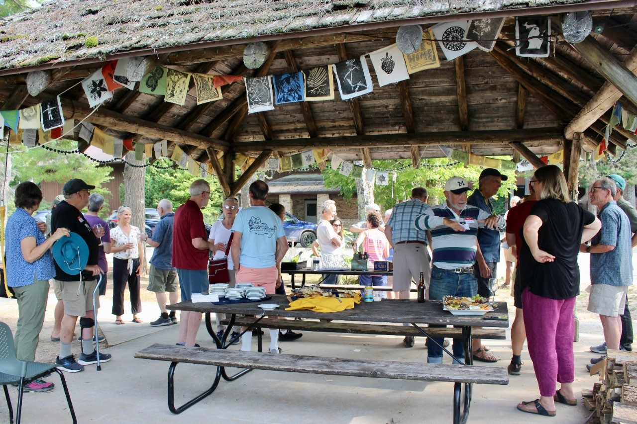 Group gathered under an outdoor pavillion