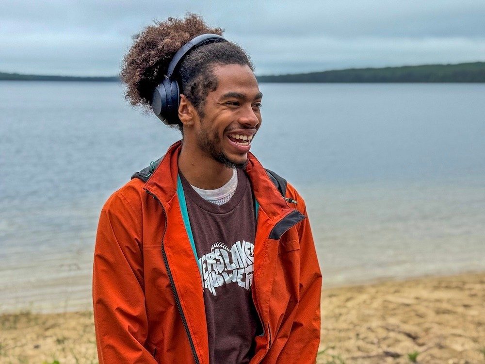 Man standing in front of a lake