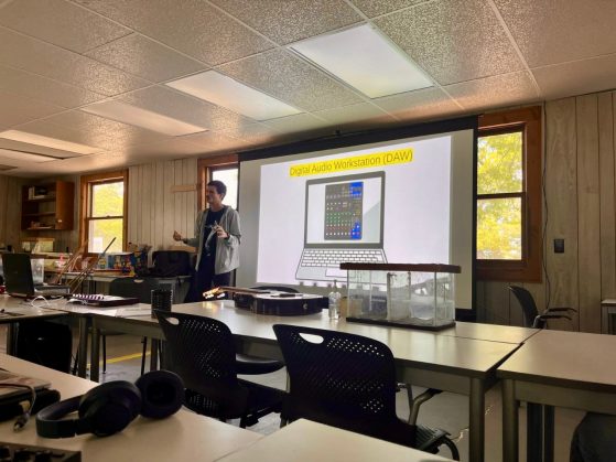 Person standing in front of a room teaching a class