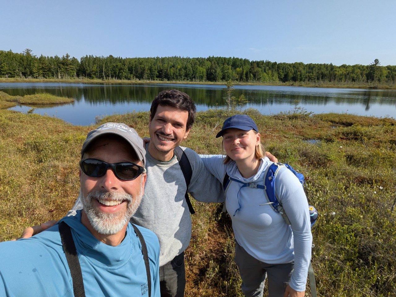 Three people at a bog