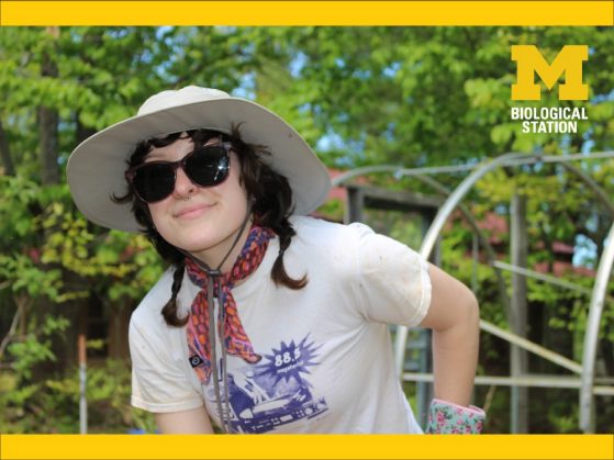 Woman wearing sunglass and hat smiles at camera