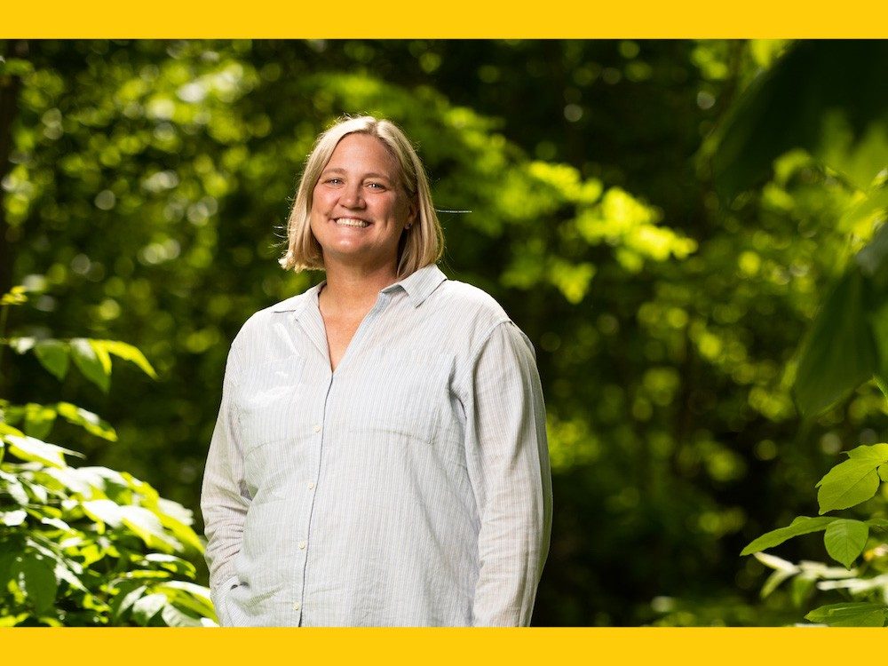 Woman in a forest smiling at camera