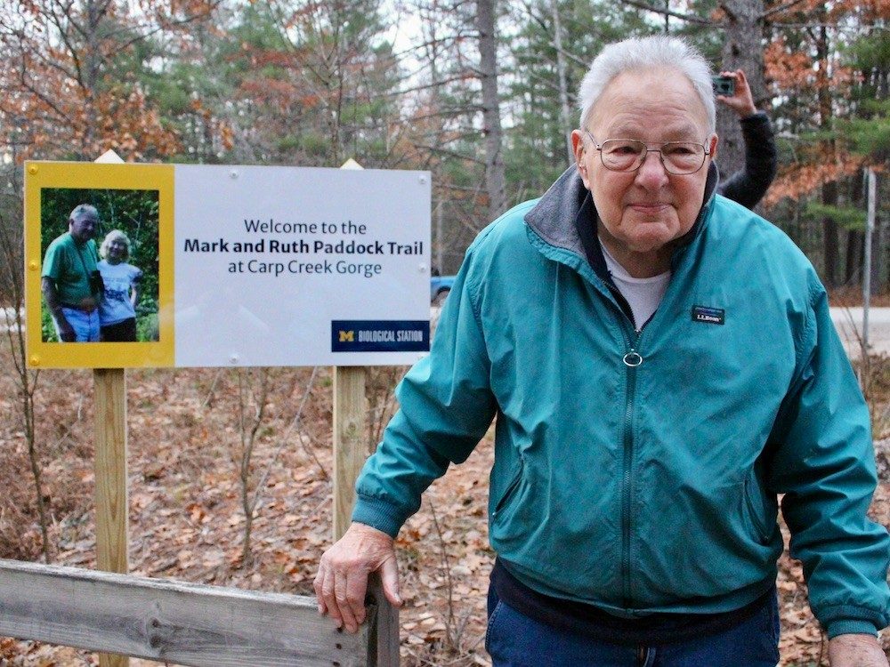 Man in front of sign
