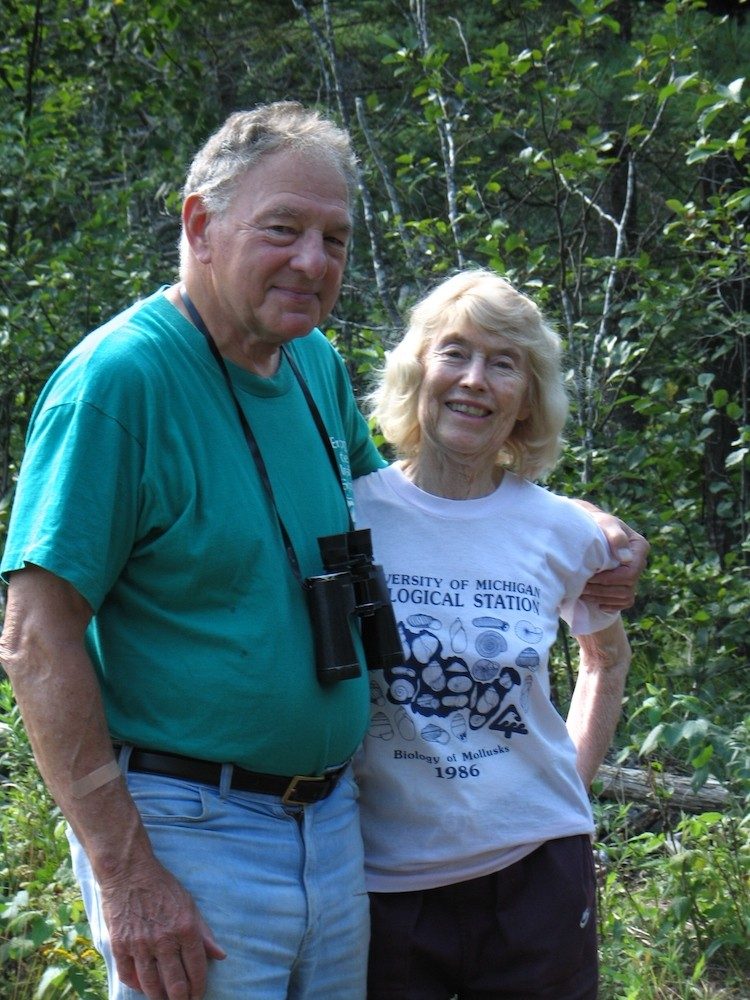 Couple standing in the woods