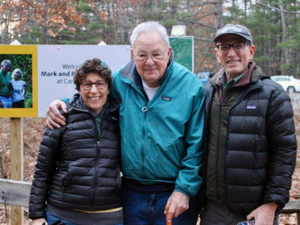 Three people smiling at camera