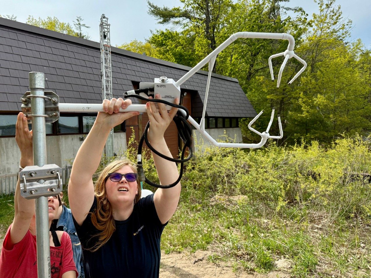 Person attaches a part to a tower