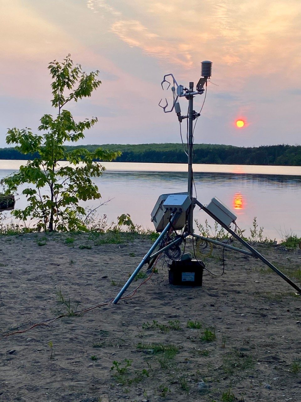 View of tower along lake at sunrise